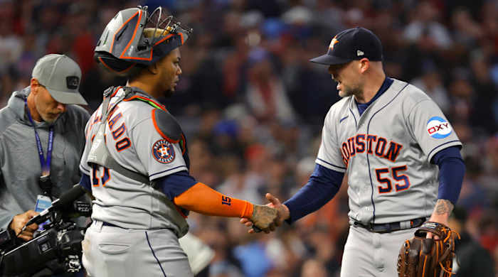 Astros relief pitcher Ryan Pressly (right) shakes hands with catcher Martín Maldonado after the ninth inning of Game 4 of the ALDS.